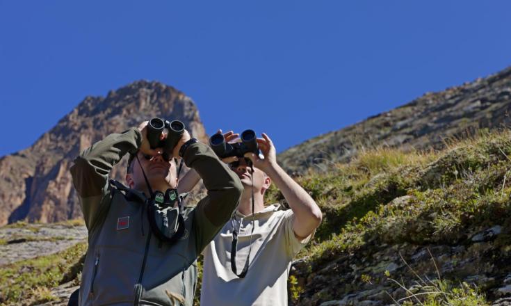 Two men with binoculars