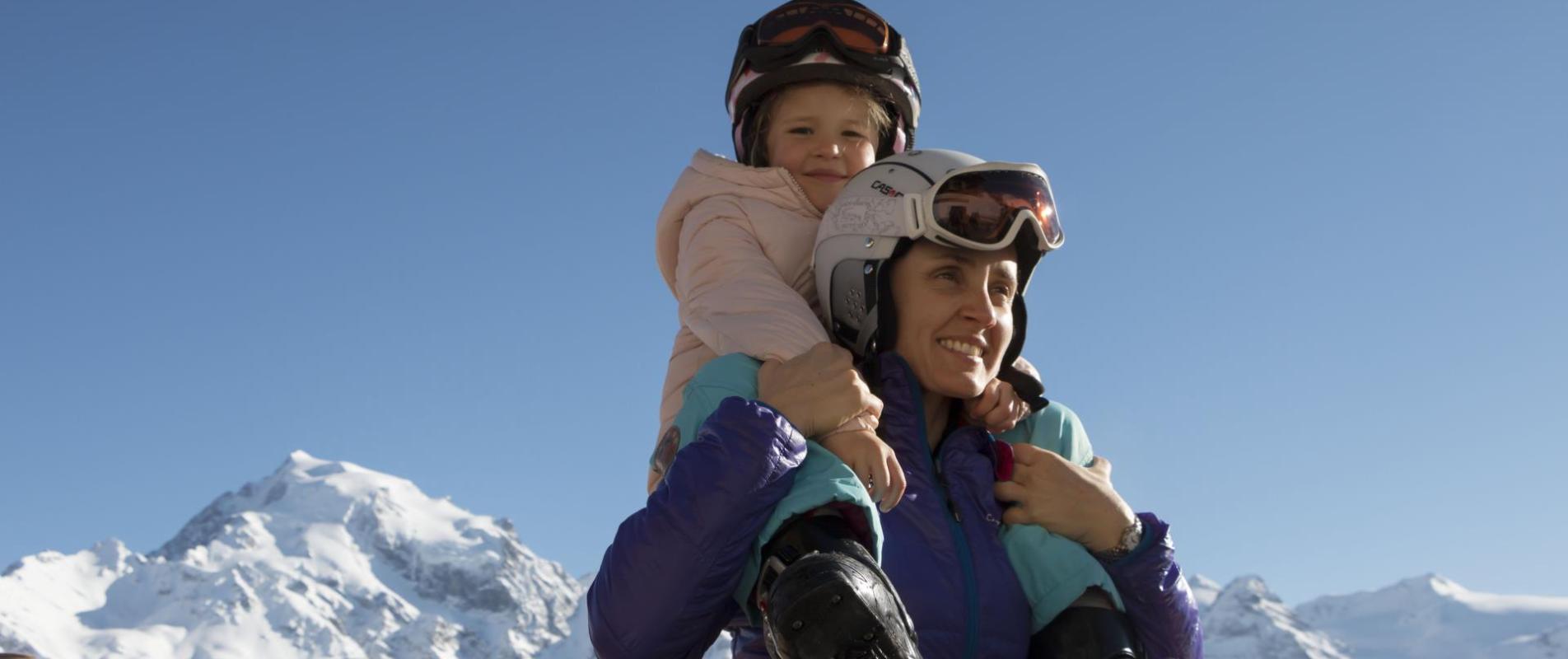 A woman has a child on her shoulders