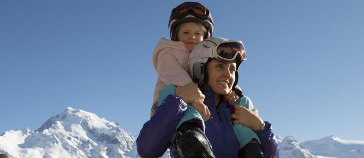 A woman has a child on her shoulders