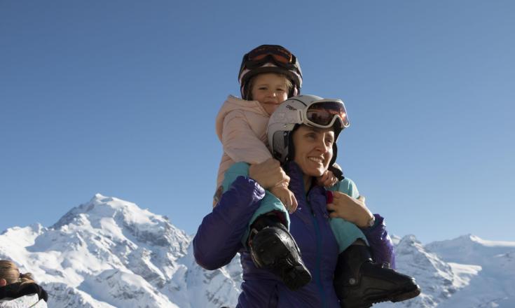 A woman has a child on her shoulders